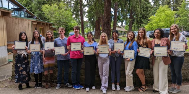 Our 2022 student scholarship recipients holding their awards