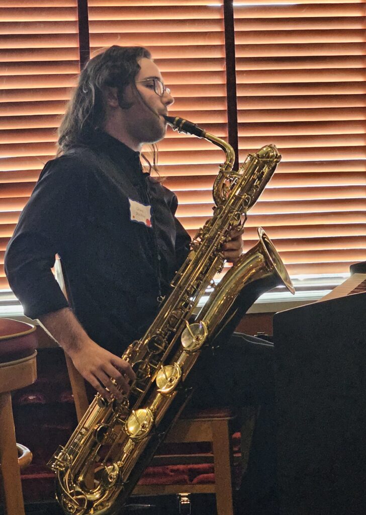 Grant Richter plays the bari sax during his live performance of his music composition, "Cave of Antiquities"