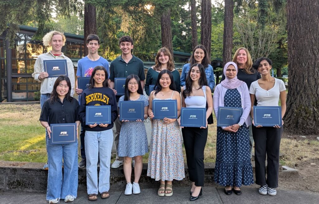 Thirteen of our 2025 scholarship recipients pose outside holding their certificates